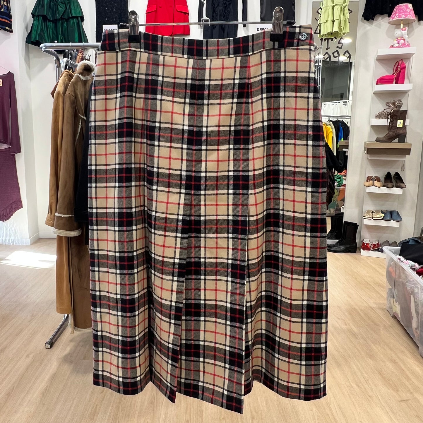 Plaid skirt hanging on a rack in a store setting