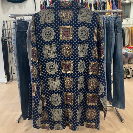 Patterned shirt on a rack with jeans in a store setting