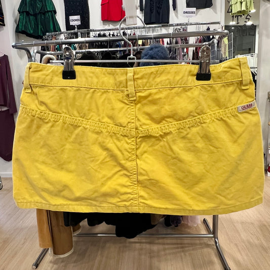Yellow skirt on a rack in a store setting