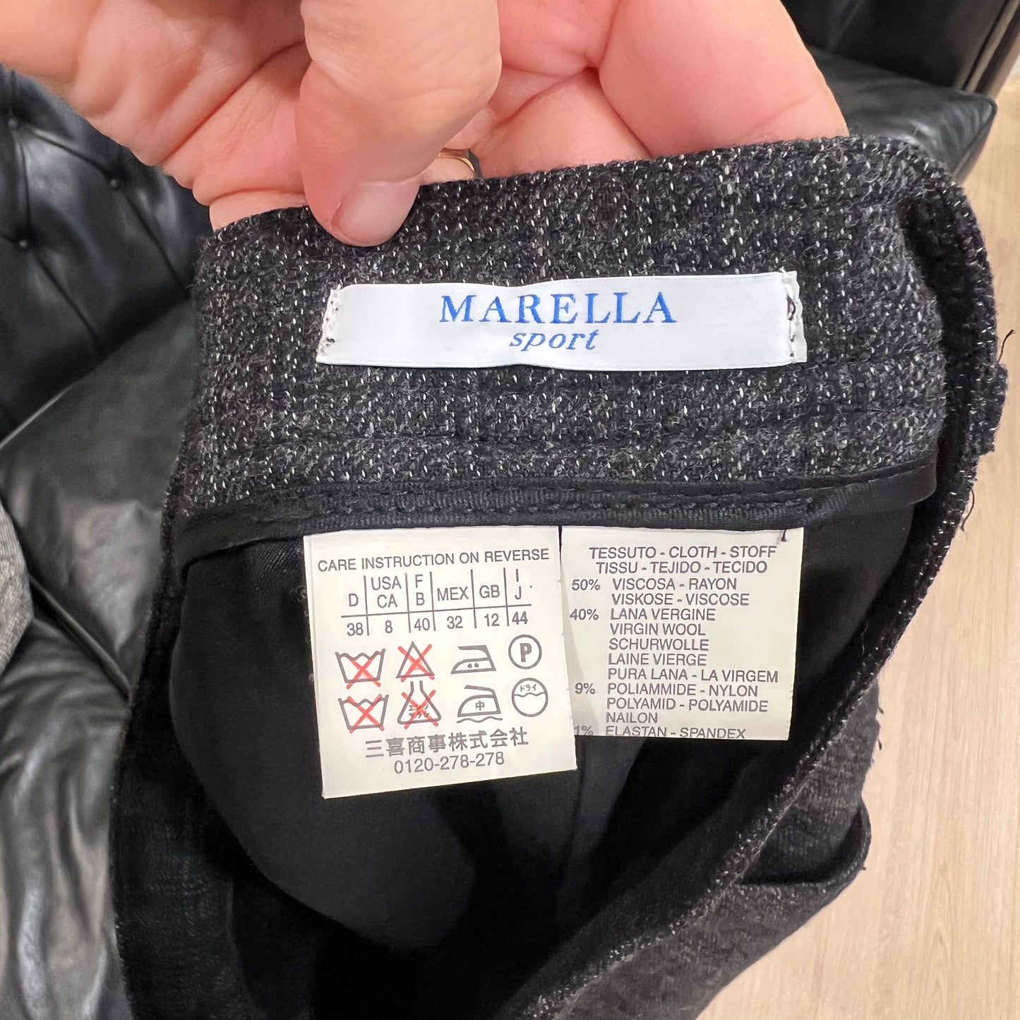 Close-up of a MARELLA label on a garment with care instructions