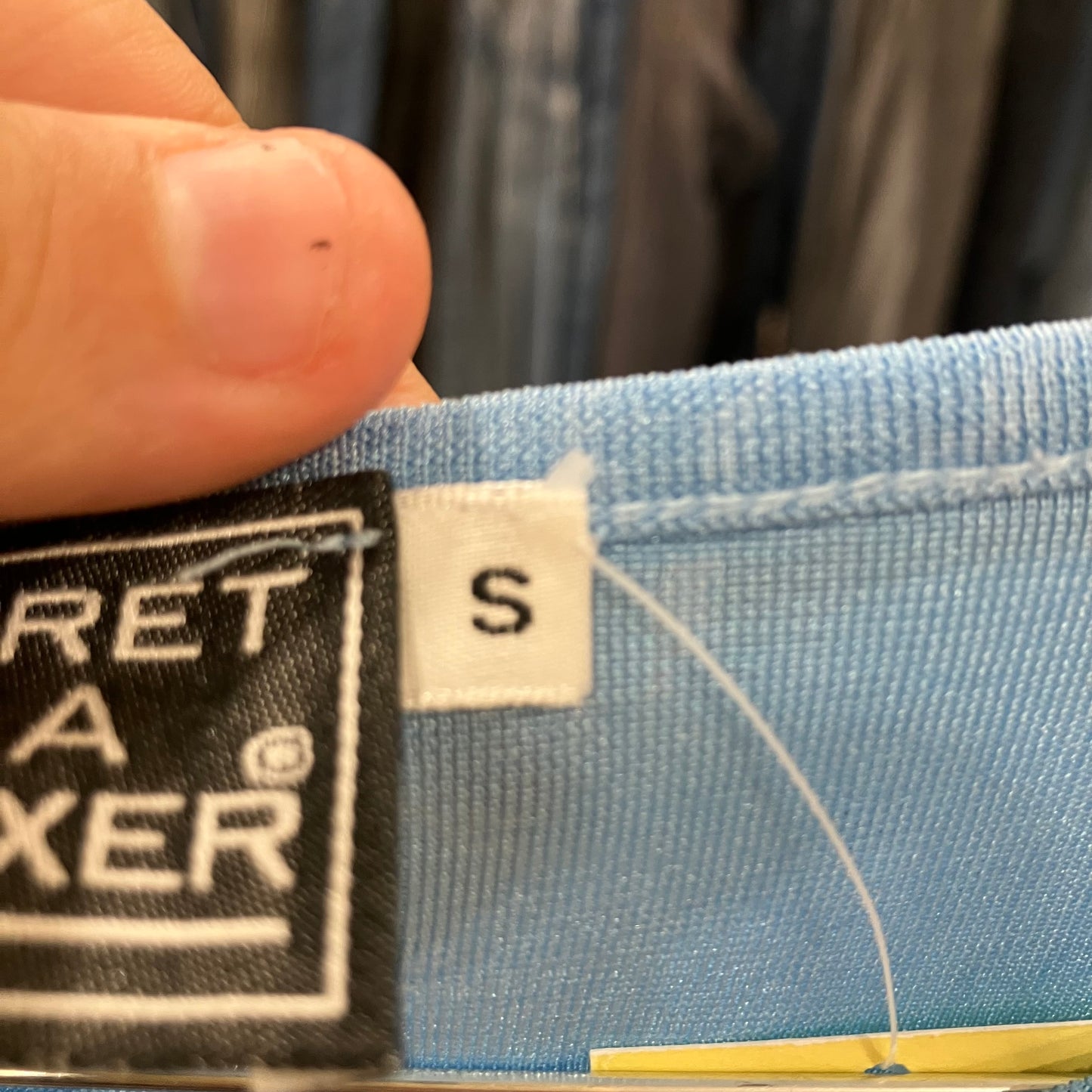 Close-up of a size label on a blue fabric item
