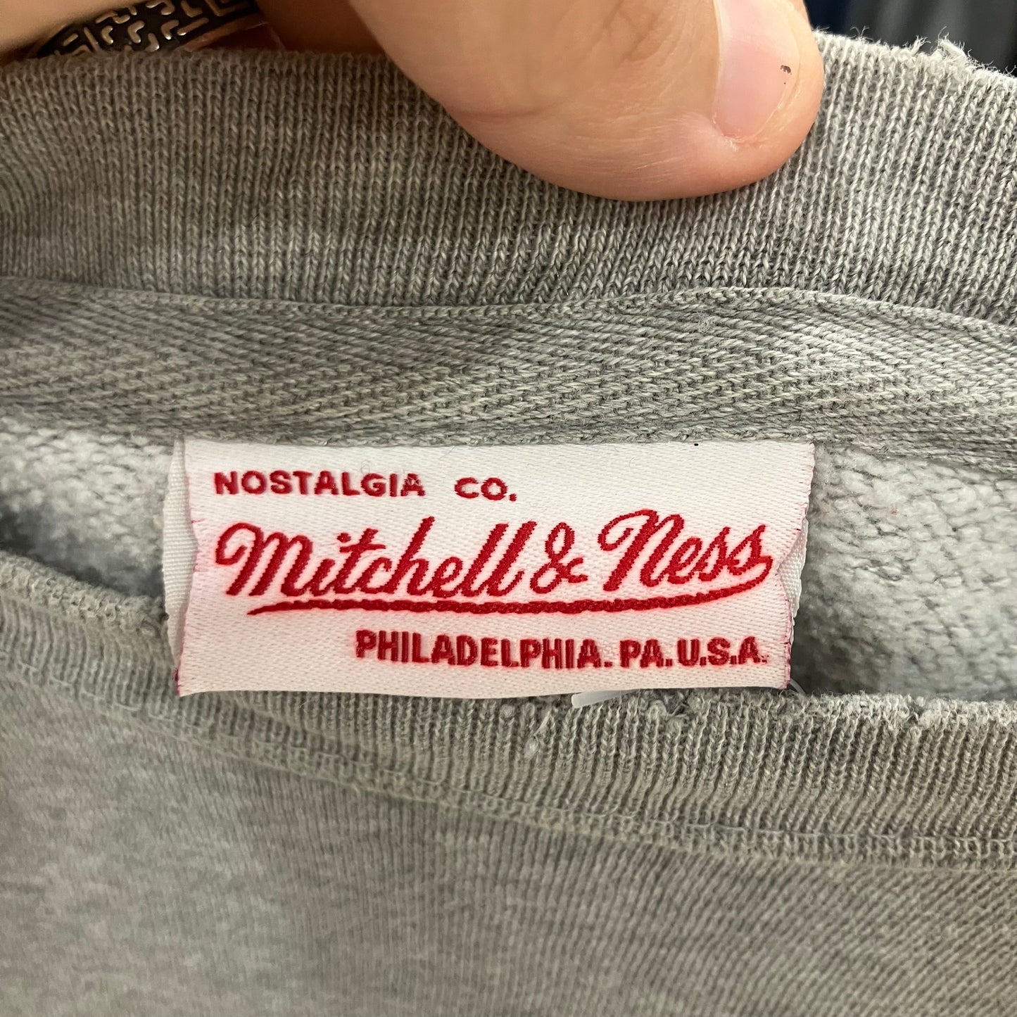 Mitchell & Ness label on a gray garment
