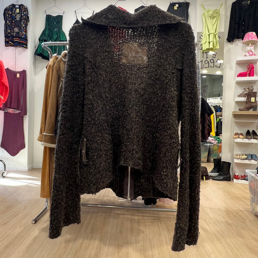 Dark textured sweater on a mannequin in a clothing store setting