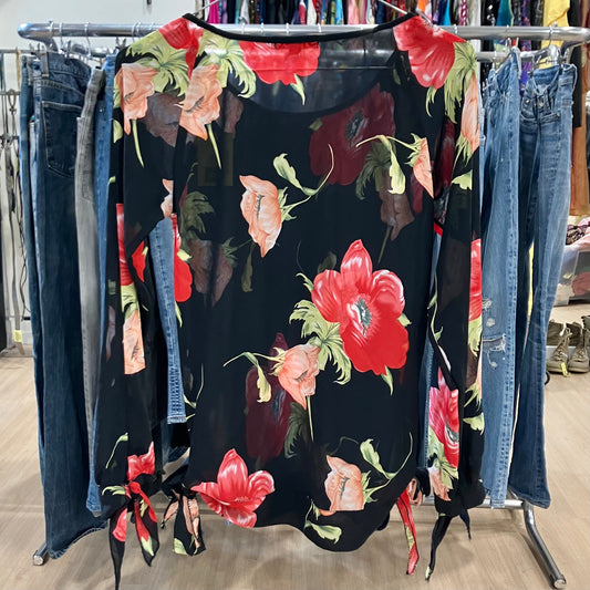 Floral dress on a rack with jeans in a store setting