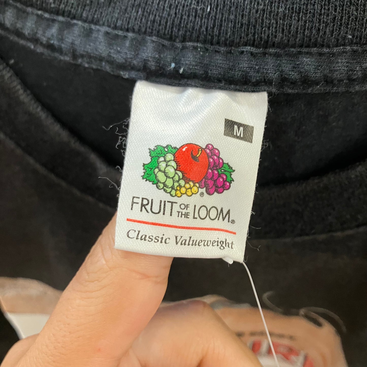 Close-up of a 'Fruit of the Loom' tag on a piece of clothing