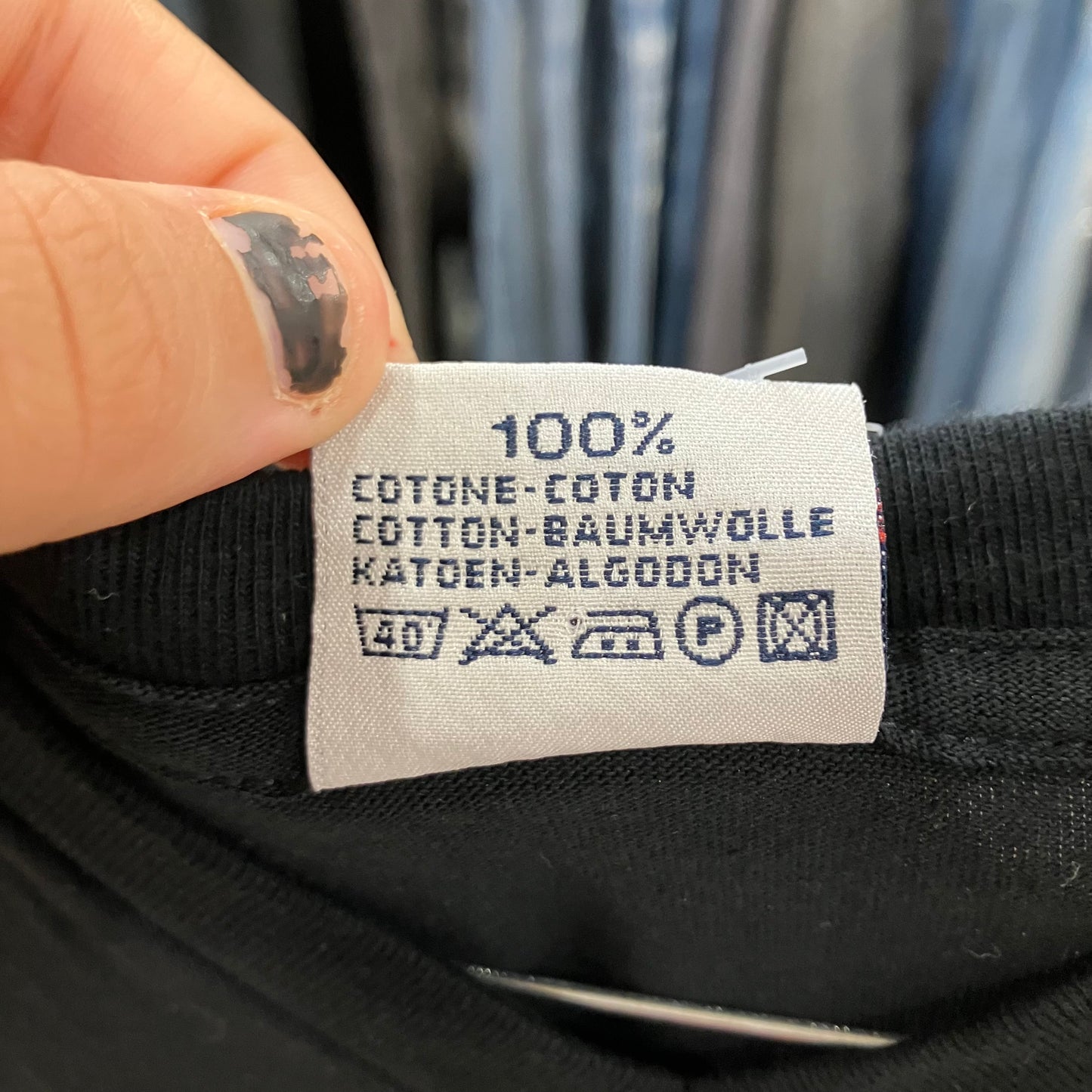 Clothing label on black fabric with text and symbols