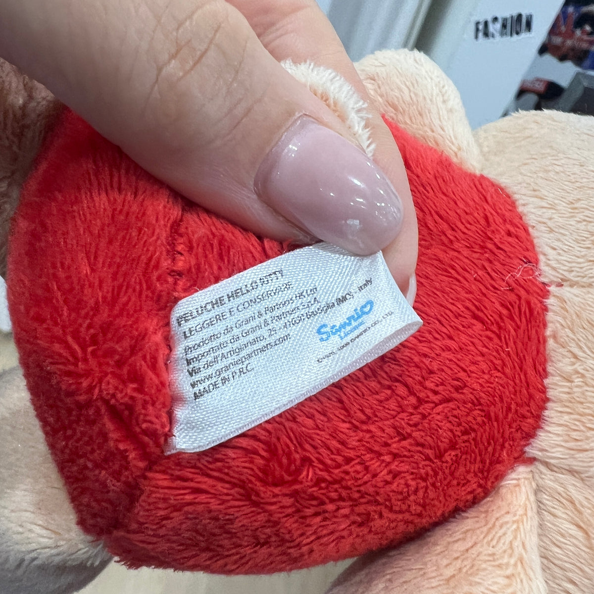 tan hello kitty plushie with red clothes
