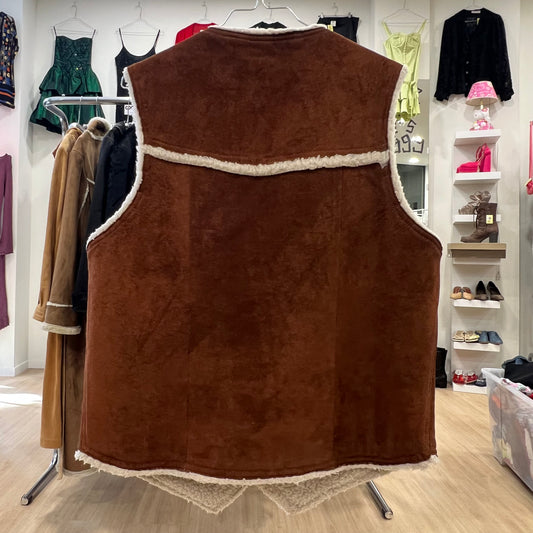 Brown fleece vest on a mannequin in a clothing store setting