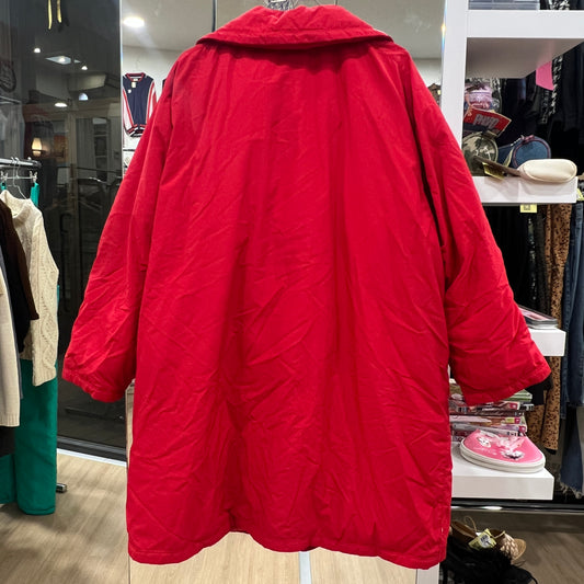Red jacket hanging in a store with various items in the background