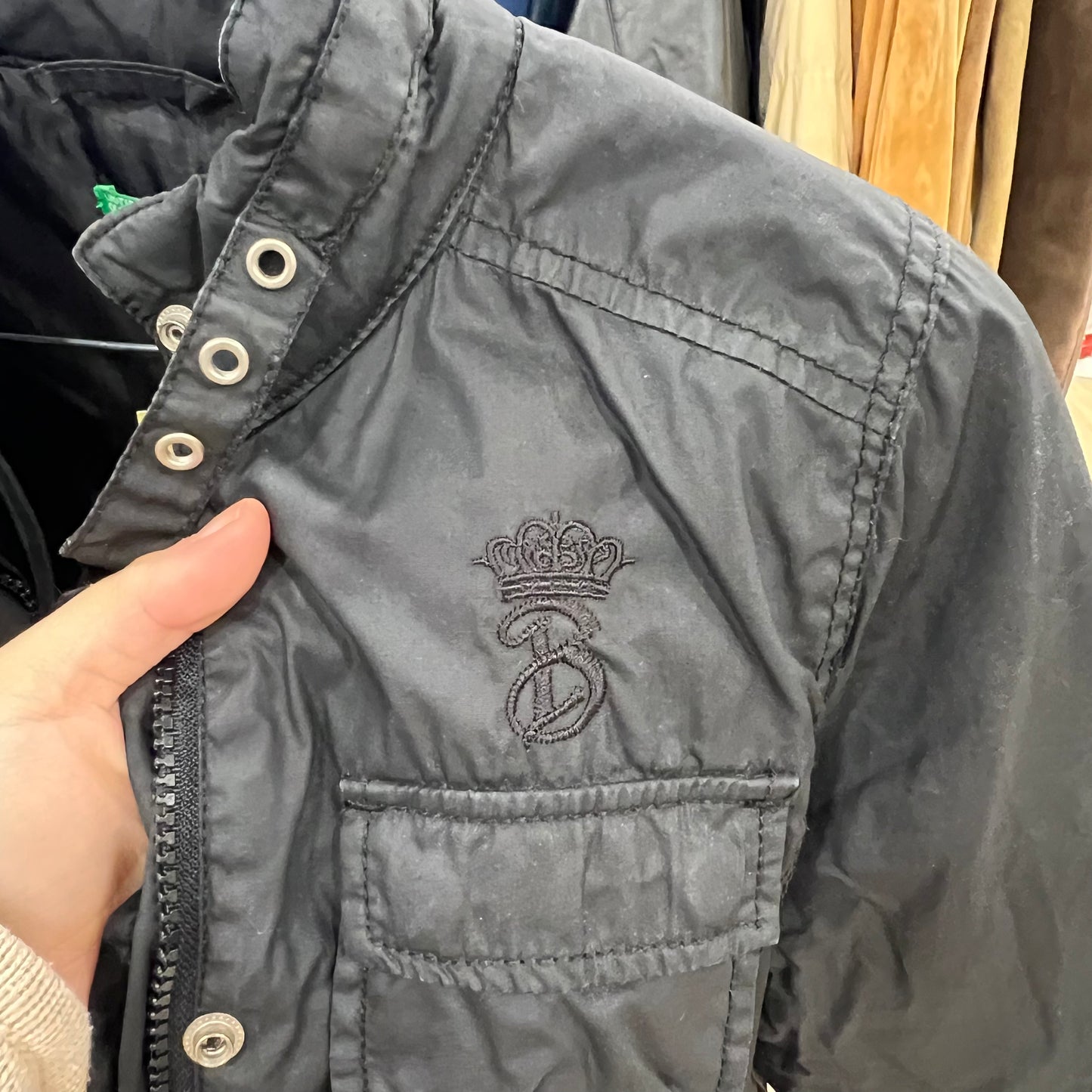 Gray jacket with a brand logo on a hanger