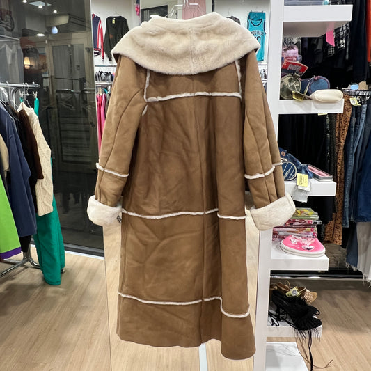 Brown coat with white trim in a store setting