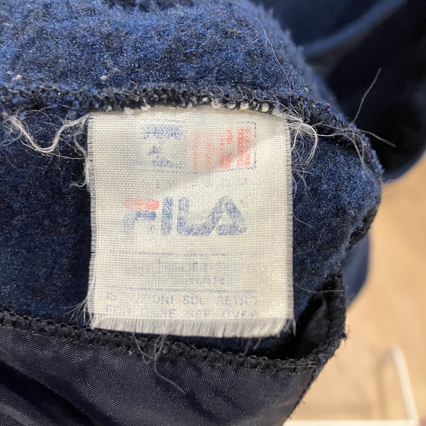 Fila label on a dark fabric background