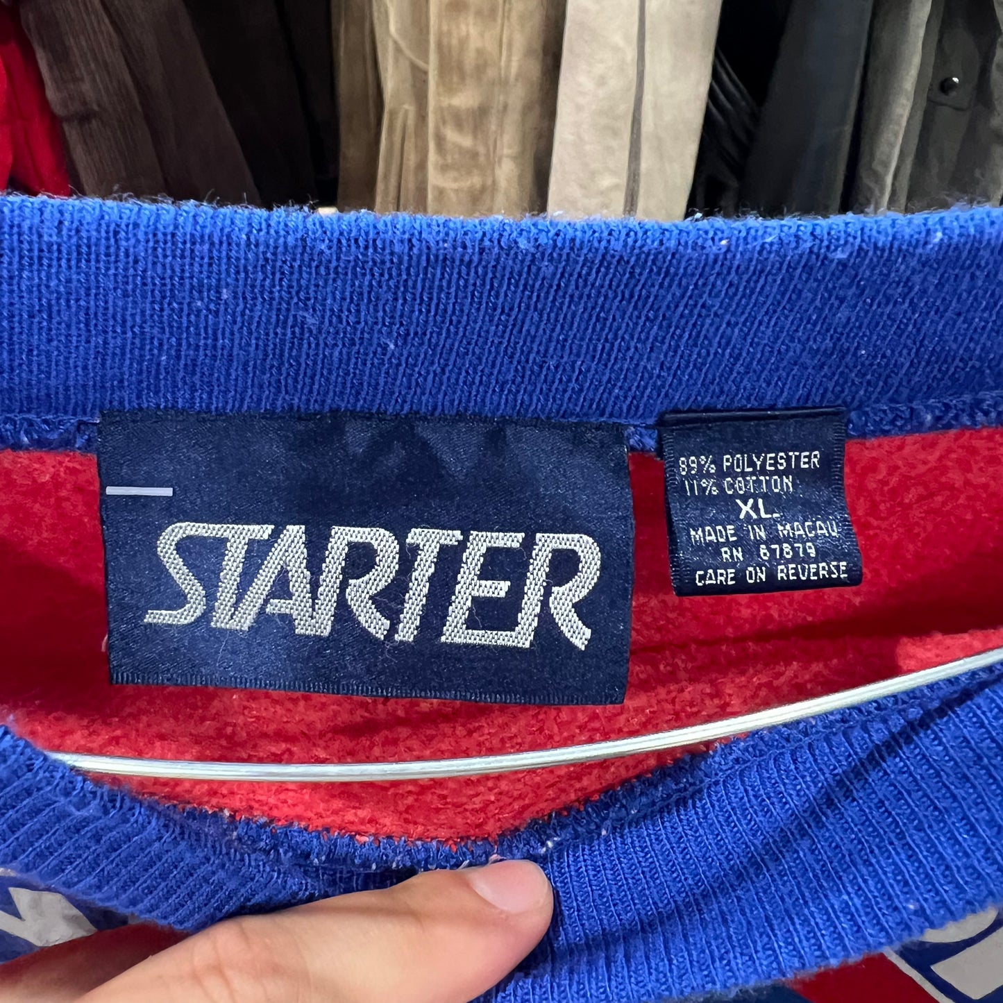 Close-up of a Starter label on a red and blue garment with visible text
