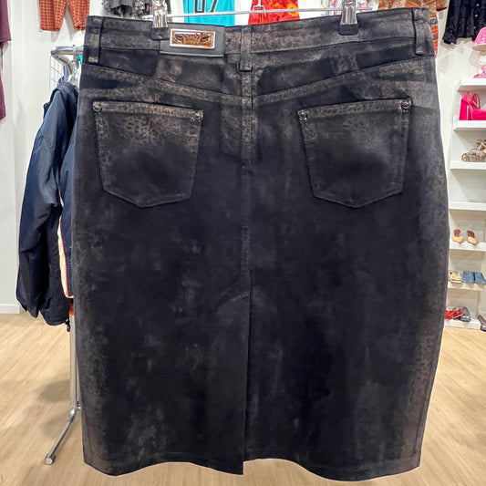 Black acid-wash skirt on a hanger in a store setting