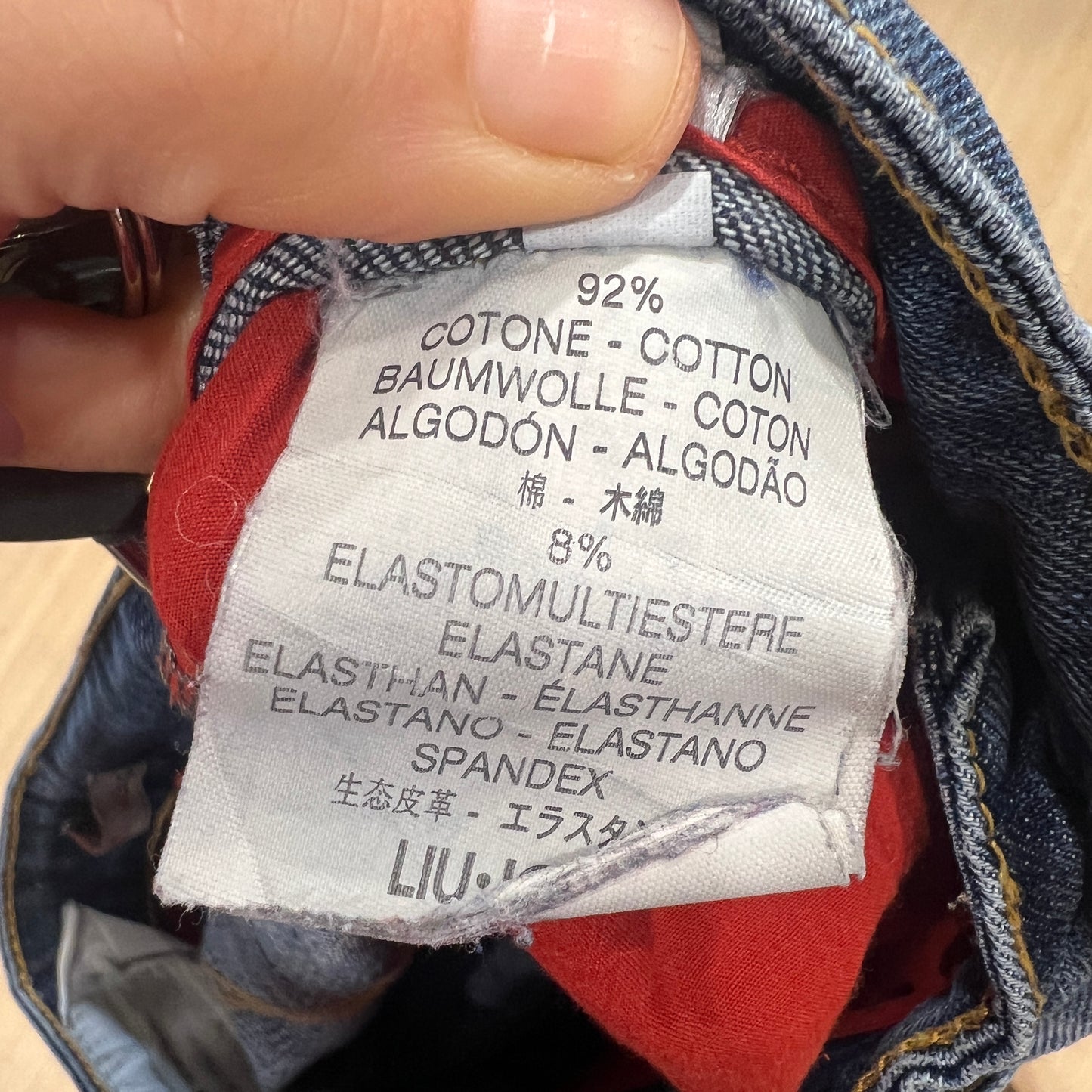 Close-up of a fabric label on a piece of clothing with text and percentages
