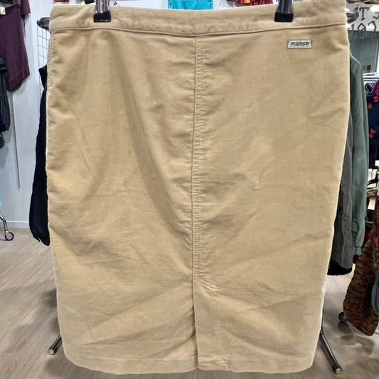 Beige skirt on a hanger in a store setting