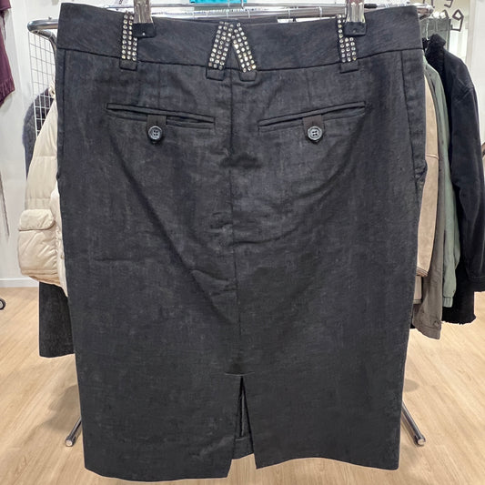 Dark gray skirt on a hanger in a store setting