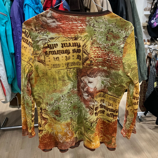 Colorful long-sleeve shirt with intricate designs and text in a store setting