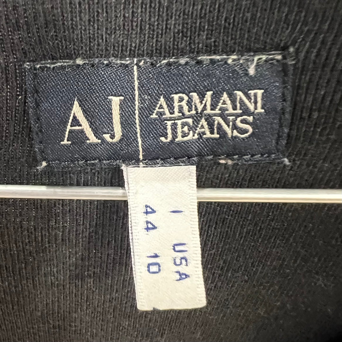 Armani Jeans label on a black fabric background