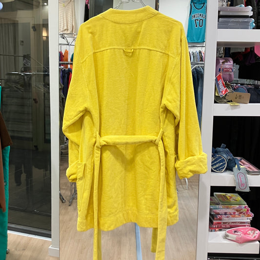 Back view of a bright yellow terry cloth bathrobe with a matching waist belt and rolled sleeves, displayed on