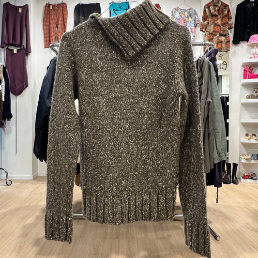 Brown knitted sweater on a mannequin in a clothing store setting