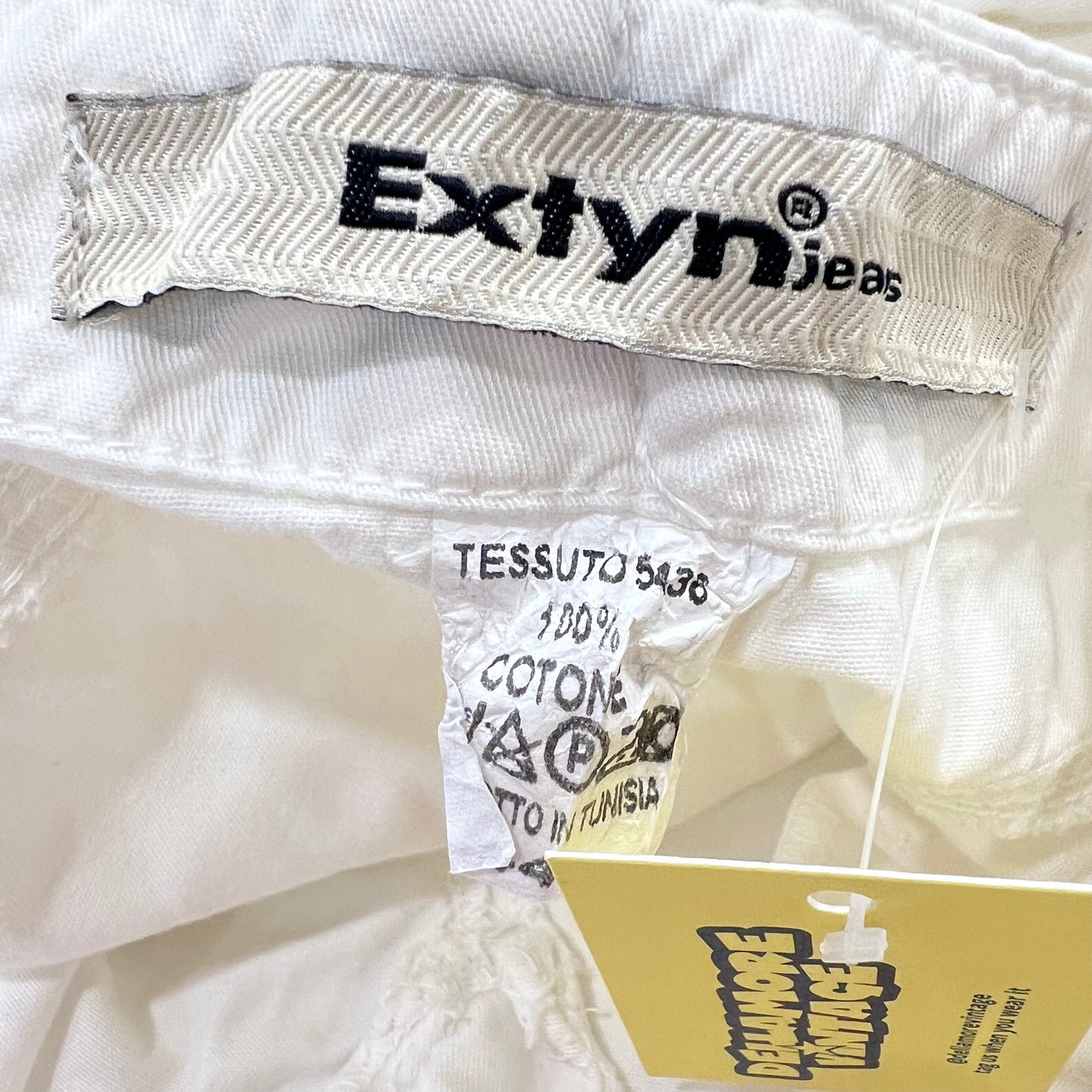 Close-up of Extyn jeans label on a white fabric background