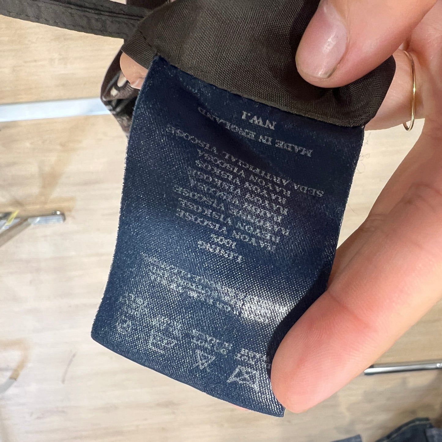 Close-up of a label on a garment with text and branding
