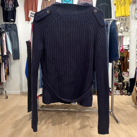 Navy blue ribbed sweater on a rack in a clothing store