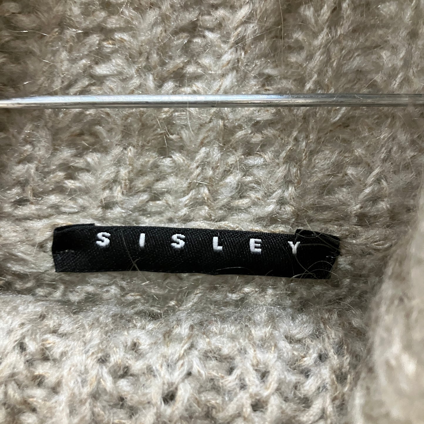 Sisley label on a textured fabric background