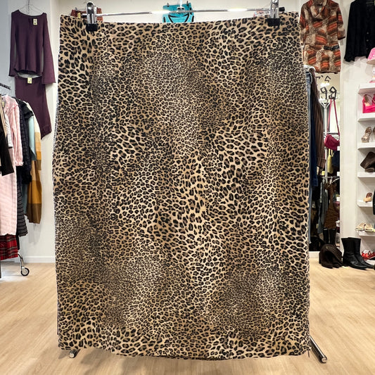 Leopard print fabric displayed in a store setting with clothing in the background