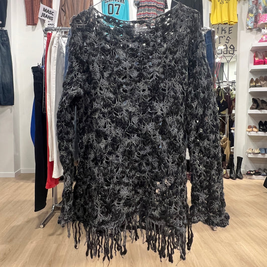 Black lace top with fringe hanging in a store