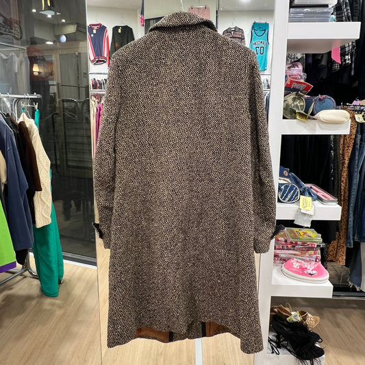 Brown textured coat in a clothing store setting