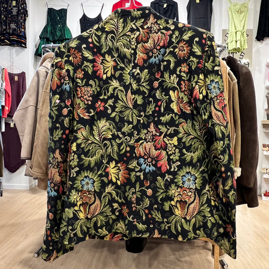 Floral patterned blazer on a rack in a store setting with other clothing items