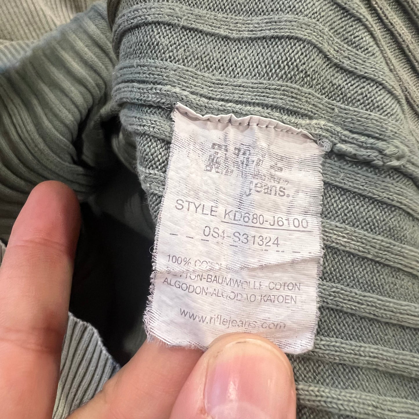 Close-up of a clothing label on a gray fabric background