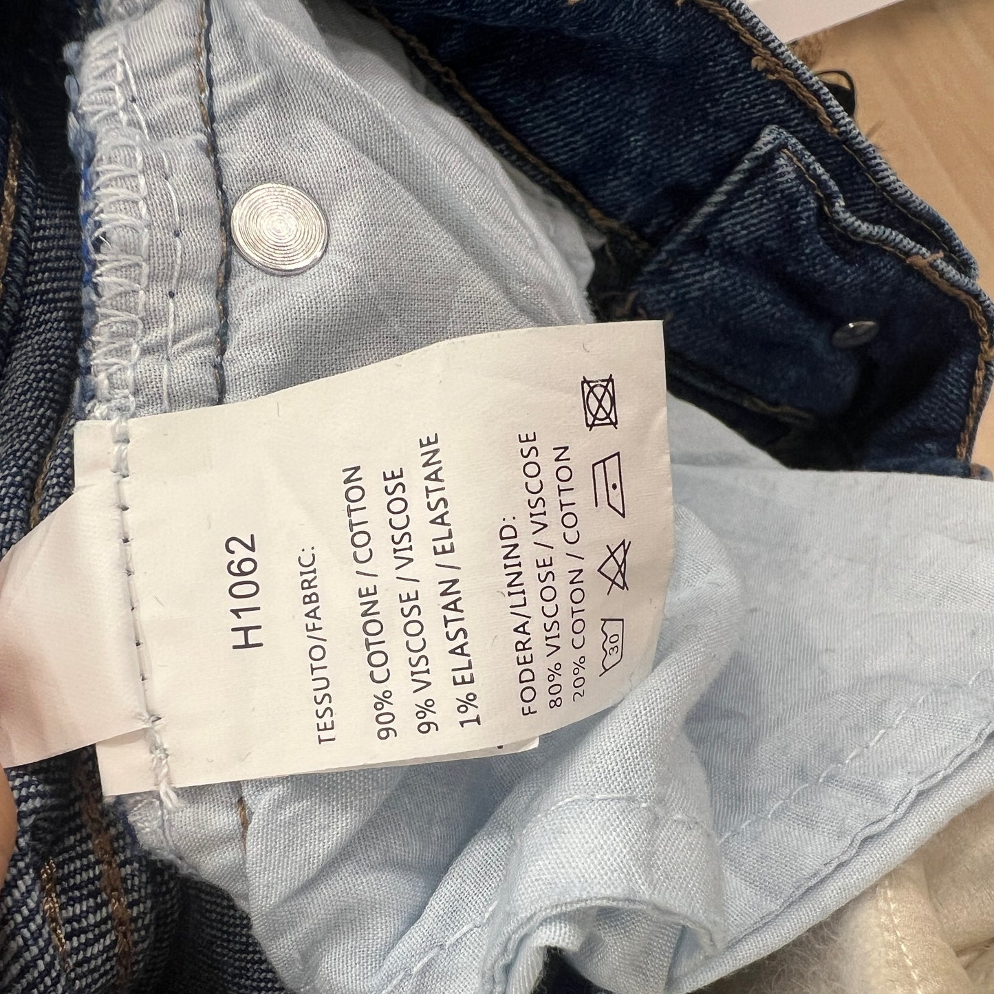 Close-up of a clothing label on denim fabric