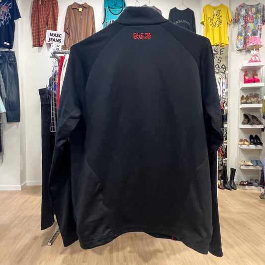 Black jacket with red logo on a rack in a clothing store