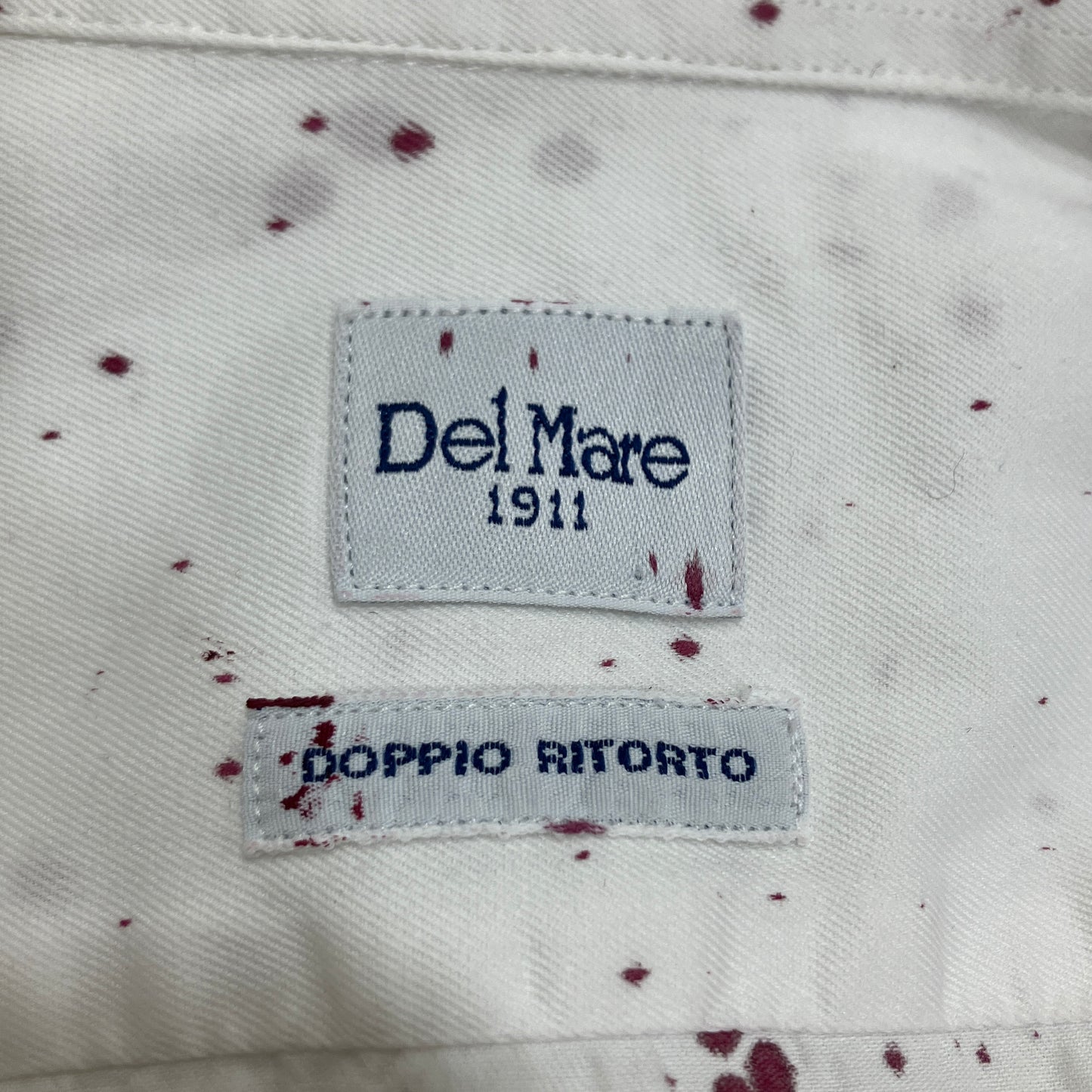 Label on a garment with 'Del Mare 1911' and 'Doppio Ritorto' text
