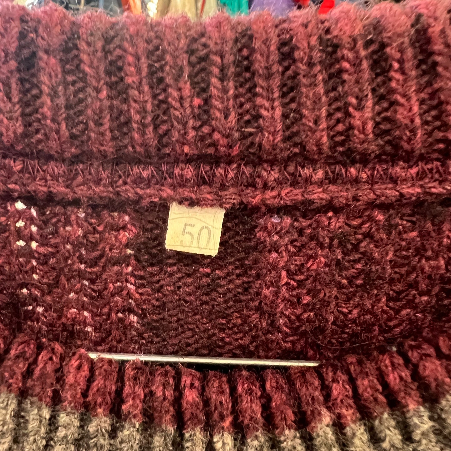 Knitted sweater with a label on a textured surface