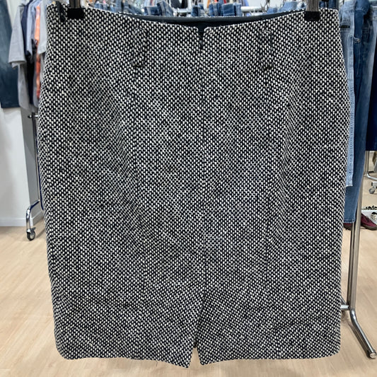 Black and white patterned skirt on a hanger in a store setting