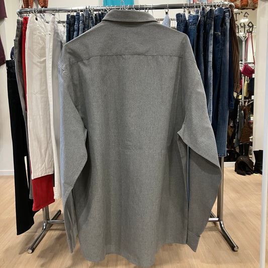 Gray shirt on a rack with other clothing in the background