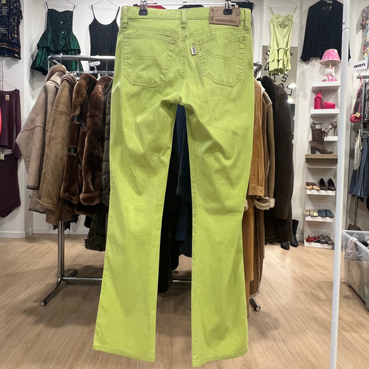 Bright green pants hanging on a rack in a clothing store