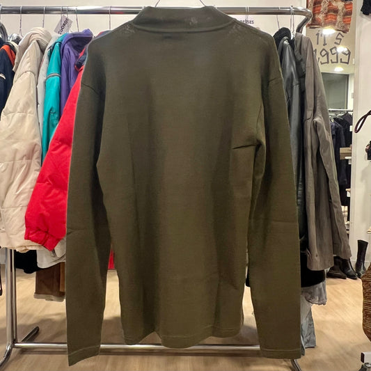 Green sweater on a rack in a clothing store