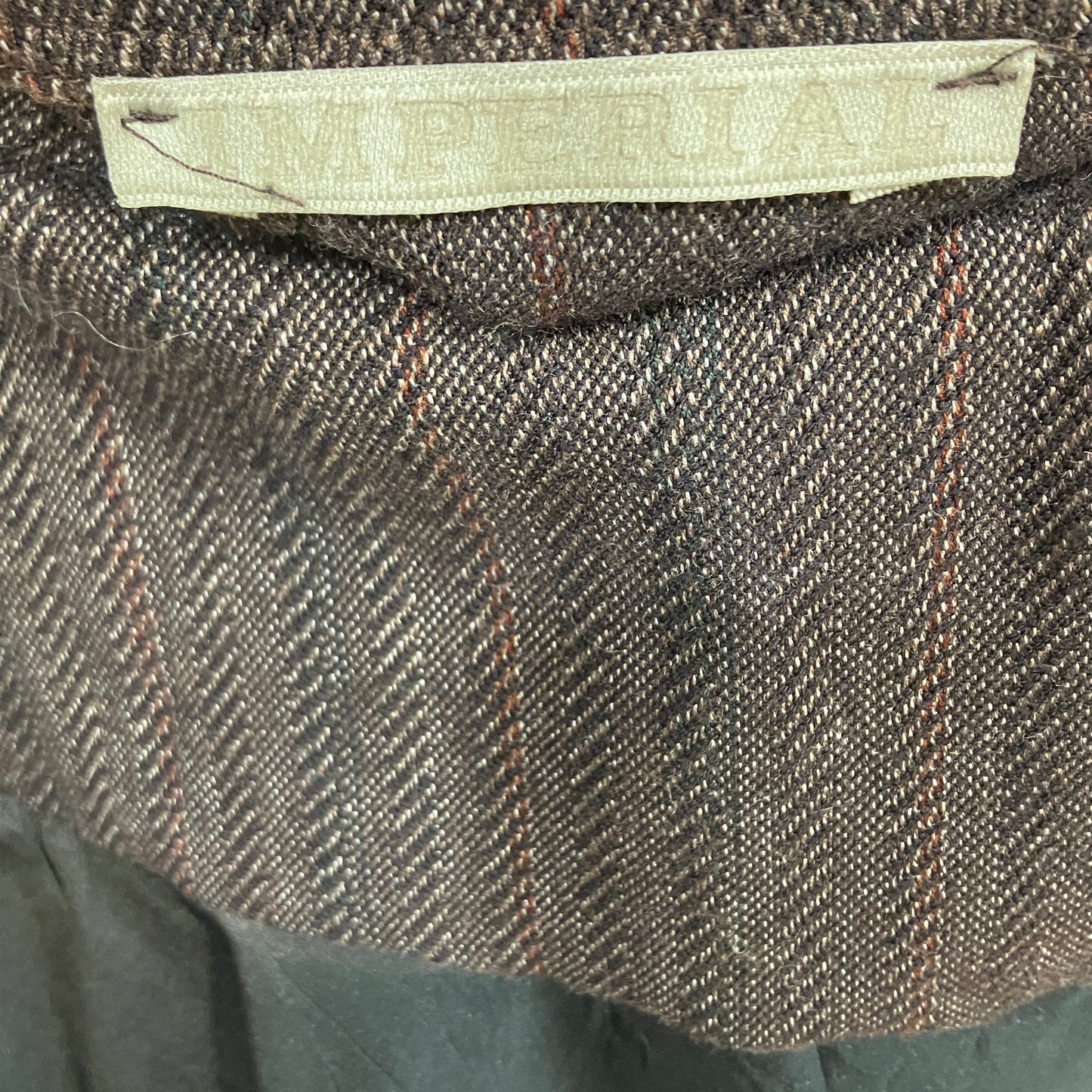 Close-up of a textured fabric with a label on a dark background