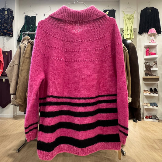 Pink sweater with black stripes hanging on a rack in a clothing store