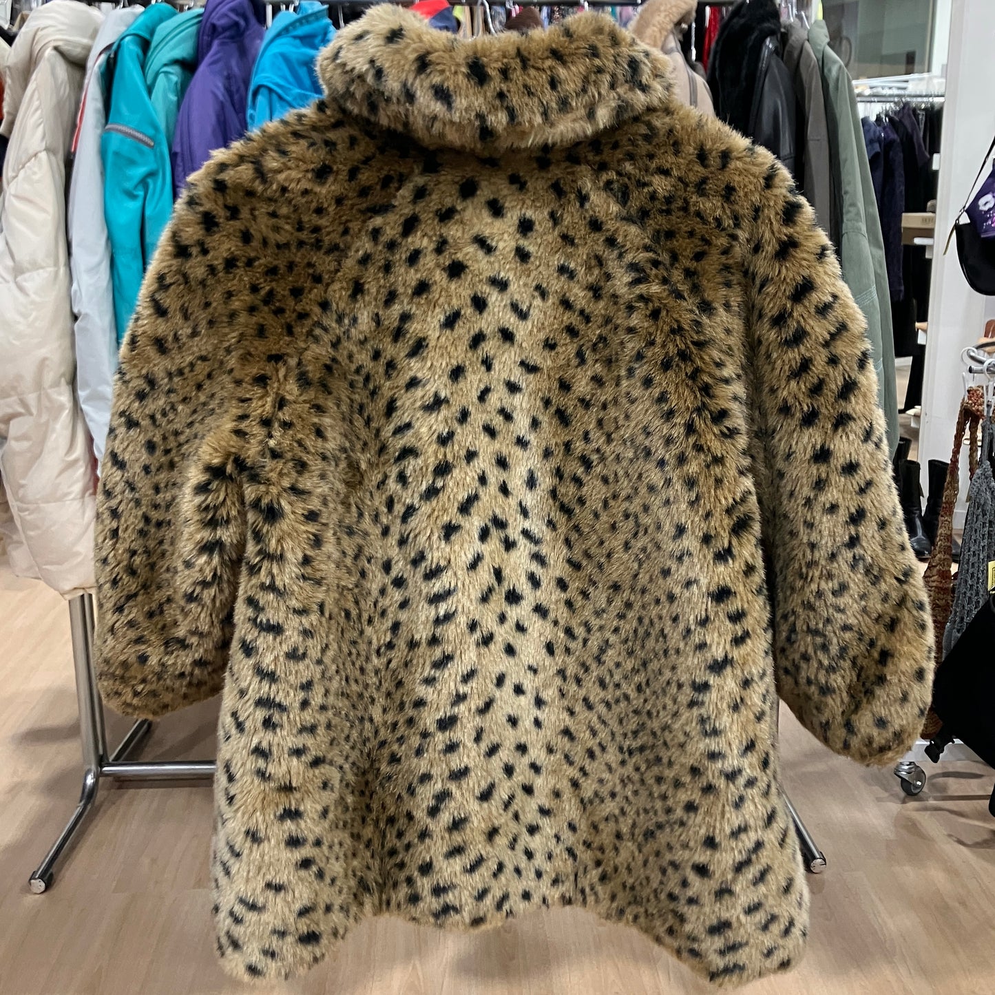 Leopard print coat on a hanger in a clothing store