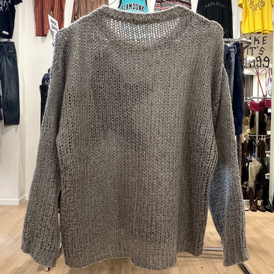 Knitted sweater on a rack in a store setting