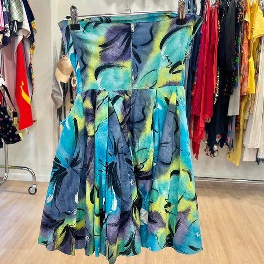Colorful dress with abstract pattern on a rack in a store