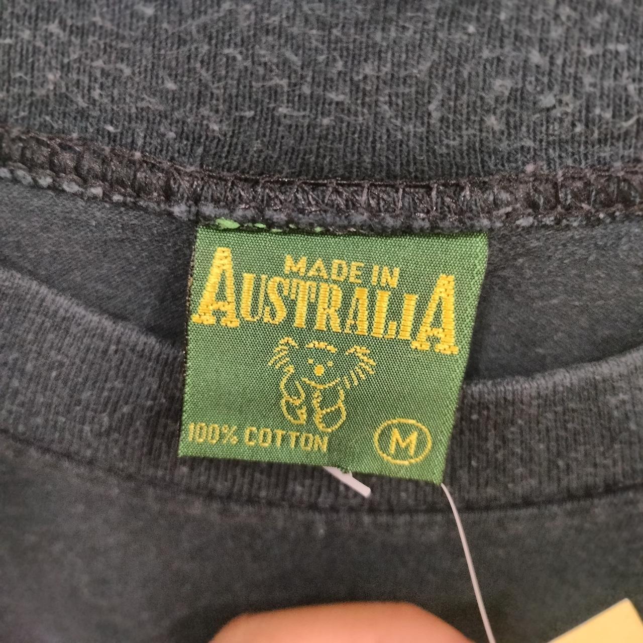 Green label on gray fabric indicating 'Made in Australia' and '100% Cotton'