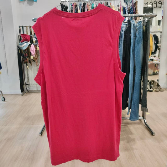 Red sleeveless top on a rack in a clothing store