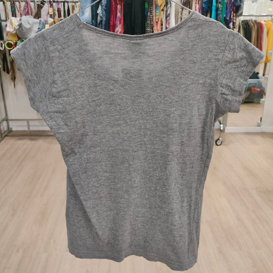 Gray short sleeve t-shirt displayed in a second hand clothing store
